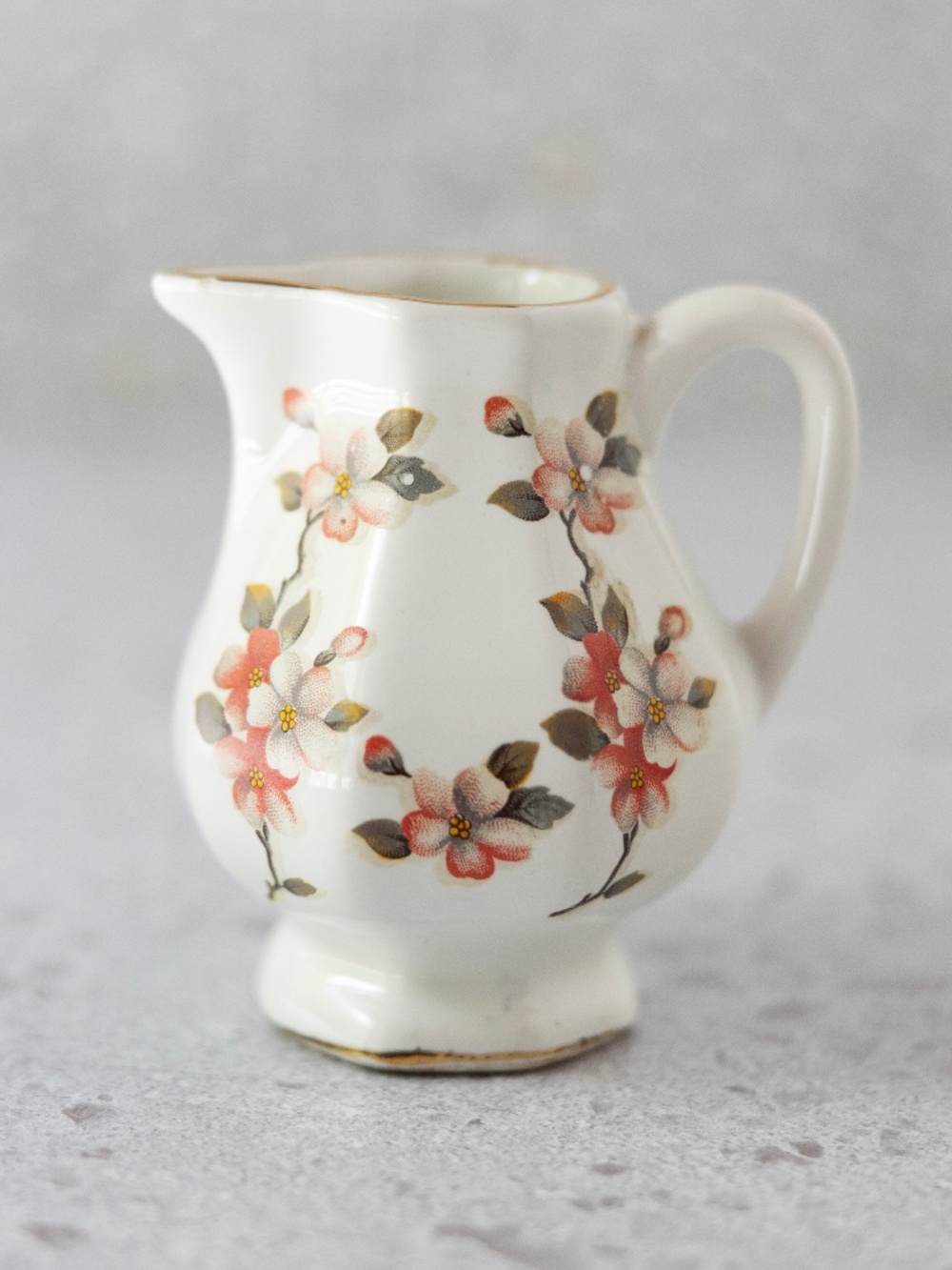 Pink floral white gold octagonal creamer with illegible marking 4" tall